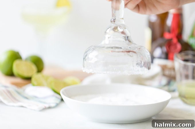 Margarita Magic 4 Dipping the rim of a cocktail glass into coarse sea salt for a classic Margarita preparation
