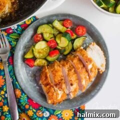 spicy oven fried chicken on a plate with side salad
