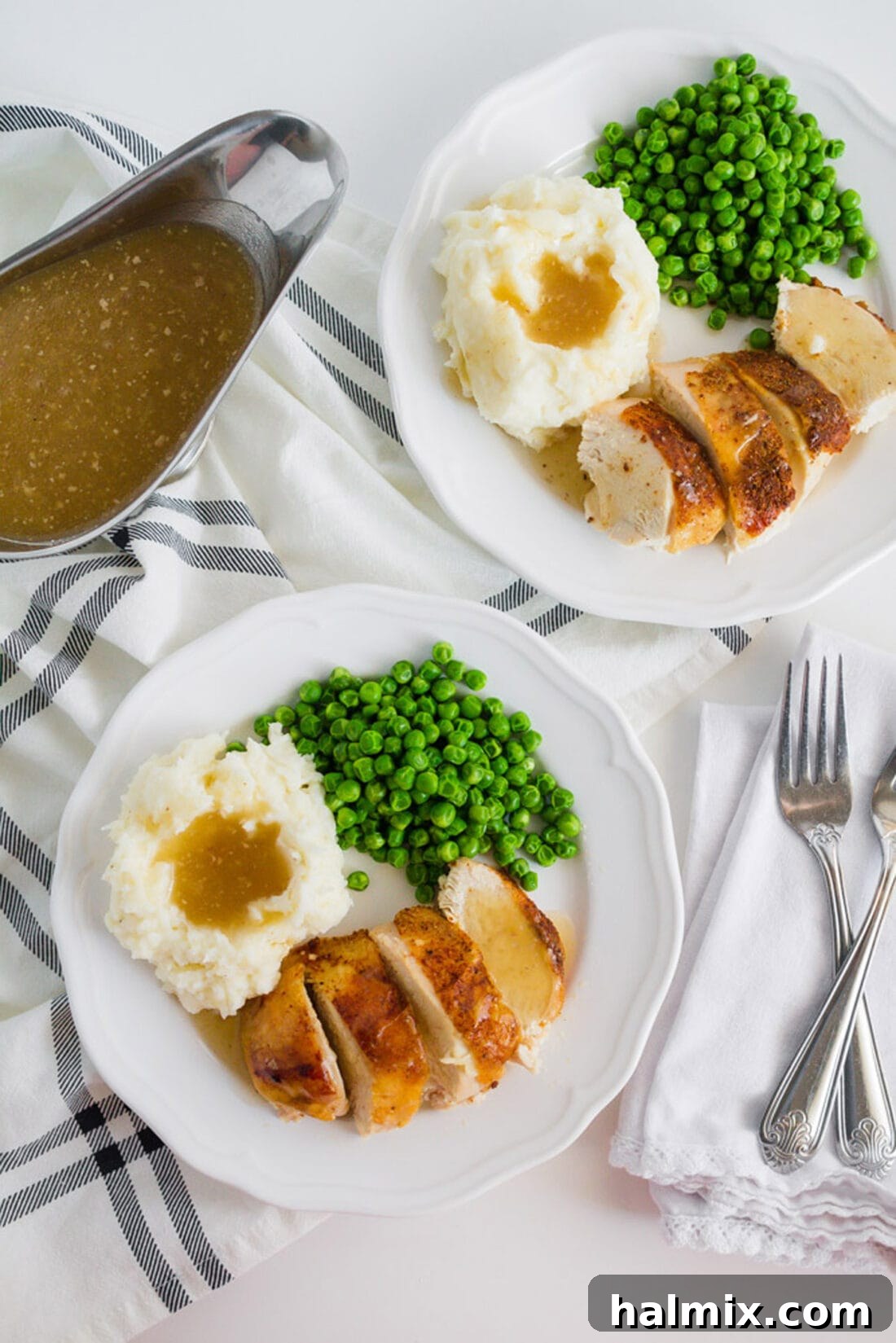 Two plates of Crockpot Sticky Chicken, each served with a generous portion of peas and creamy mashed potatoes, showcasing a complete and appealing meal.