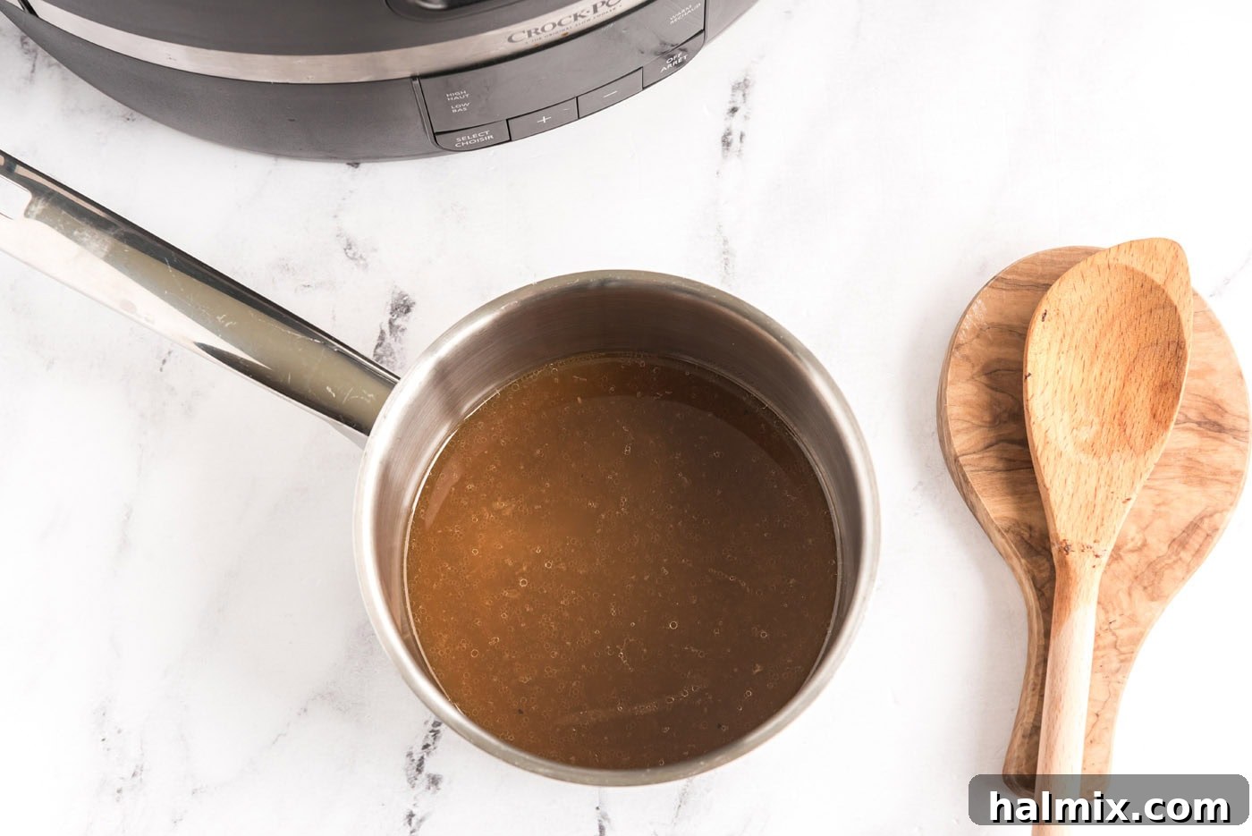 Perfect Slow Cooker Pot Roast 11 pan juices in a saucepan