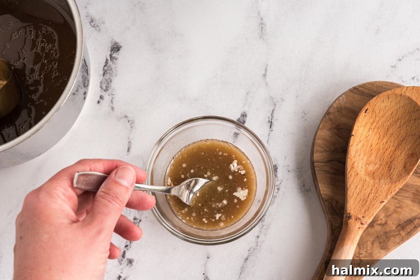 Perfect Slow Cooker Pot Roast 12 whisking cornstarch with pan juices in a bowl