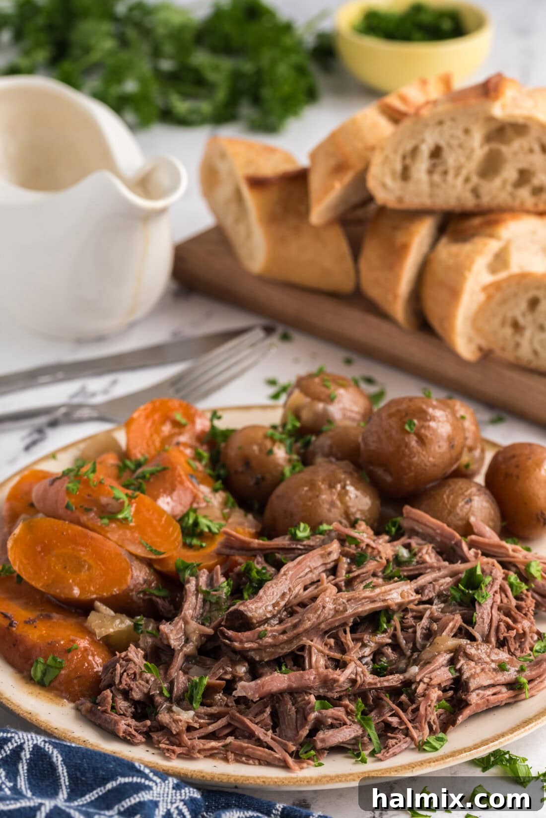 Perfect Slow Cooker Pot Roast 14 Shredded Crockpot Roast Beef on a platter with potatoes and carrots