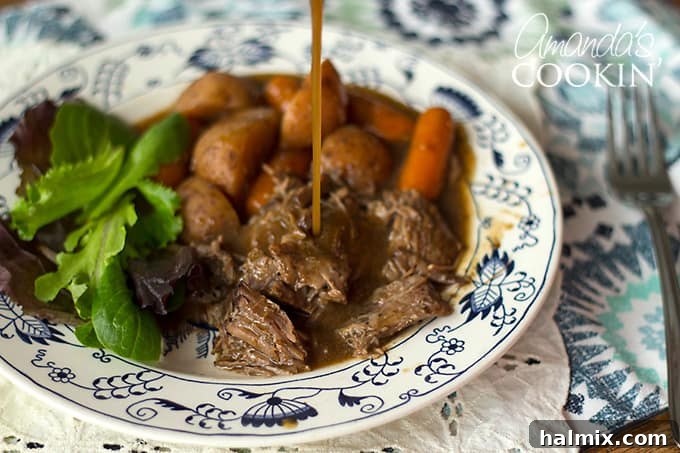 I have been making this crockpot roast beef for many, many years. This roast only needs a few ingredients and cooks all day in your slow cooker to perfection. #crockpotroast #crockpotroastbeef #slowcookerroast #crockpotpotroast #crockpotdinners #crockpotrecipes #slowcookerrecipes #chuckroast #weeknightdinners Gravy pouring onto crockpot roast beef and carrots