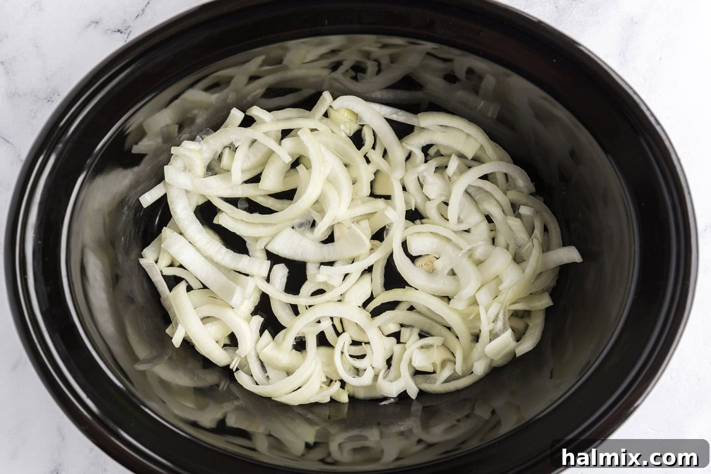 Perfect Slow Cooker Pot Roast 5 sliced onions on bottom of slow cooker crock