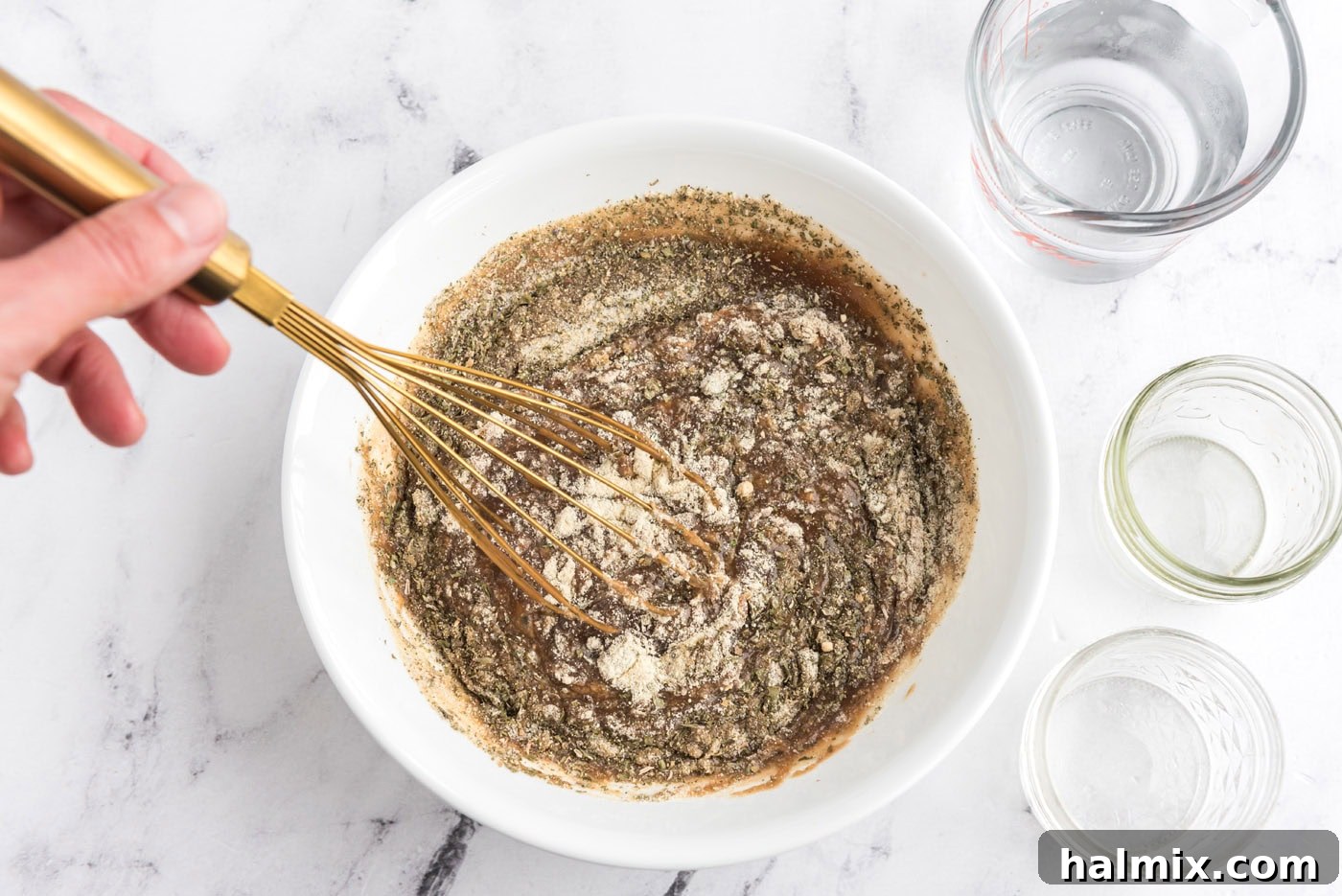 Perfect Slow Cooker Pot Roast 8 whisking gravy, ranch dressing mix, and italian dressing mix in a bowl