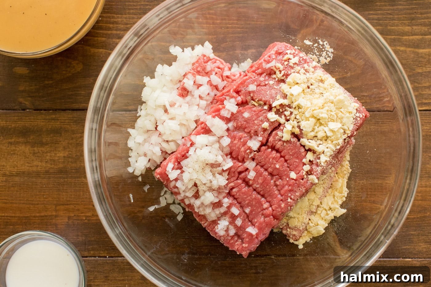 Hearty Salisbury Steaks 5 Ground beef mixture in a bowl with crushed saltines and minced onion, ready to be mixed for Salisbury steaks.