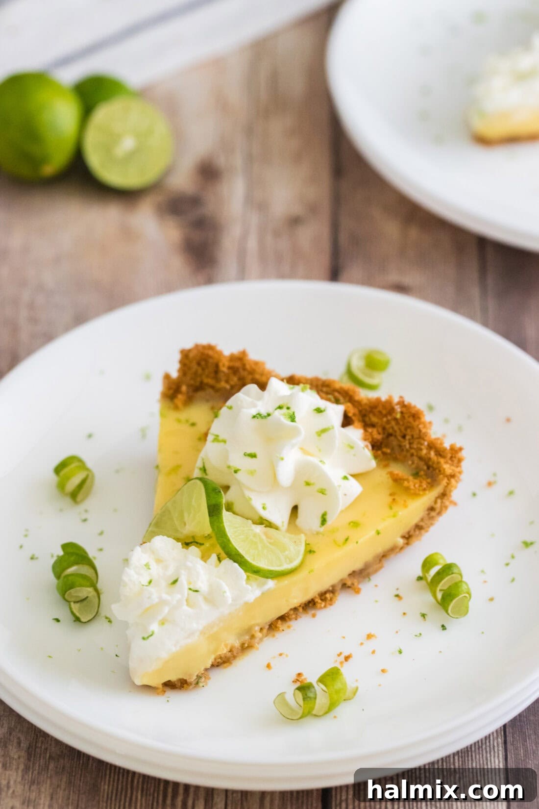 Refreshing Lime Perfection 3 A vibrant slice of Key Lime Pie, adorned with whipped cream and a lime twist, served elegantly on a plate