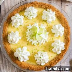 A mouthwatering overhead view of a complete Key Lime Pie, garnished beautifully