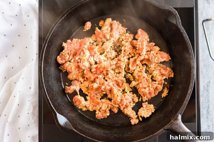 Crafting Delicious Homemade Pizza Sausage 7 ground pork sausage being browned in a cast iron skillet
