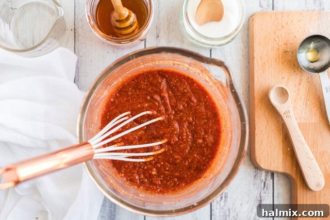 bowl of sauce with a whisk