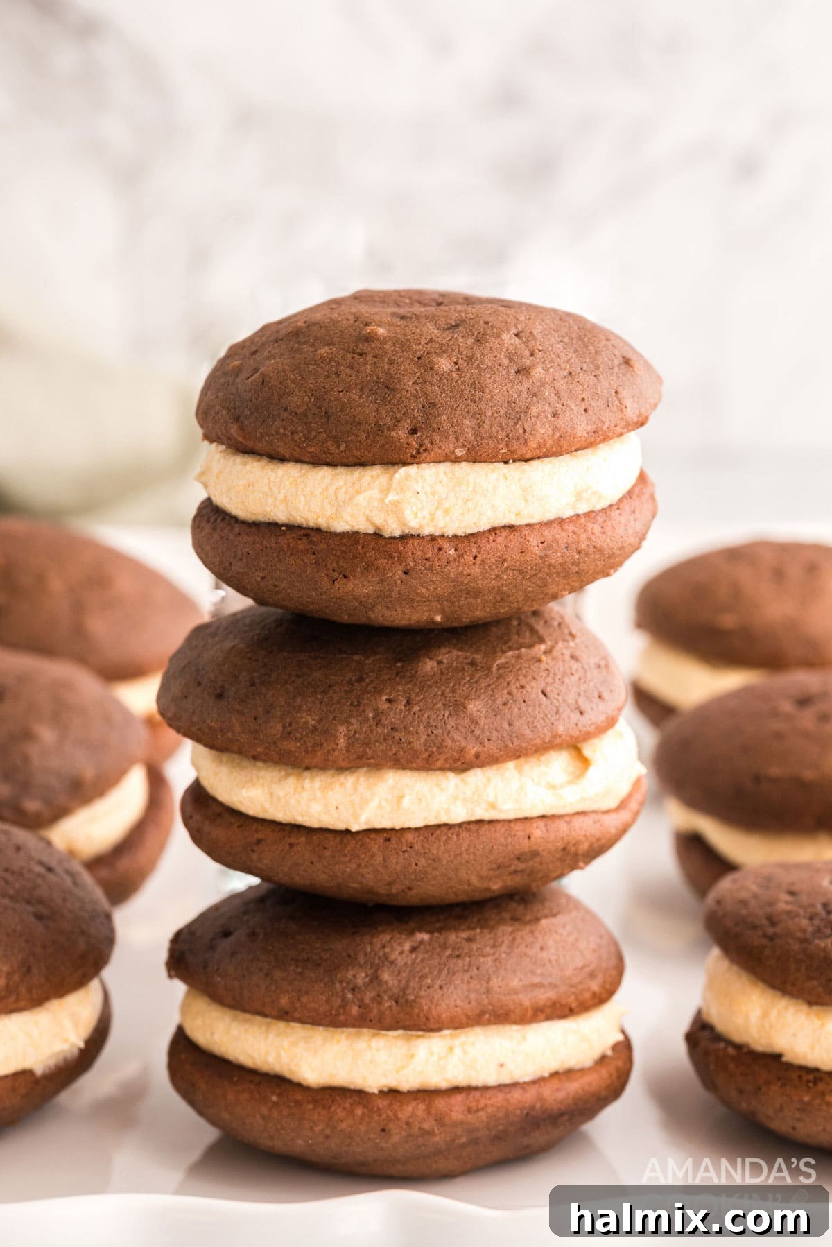 An appetizing stack of finished mini pumpkin whoopie pies, showcasing their delightful appearance and readiness for a fall treat.