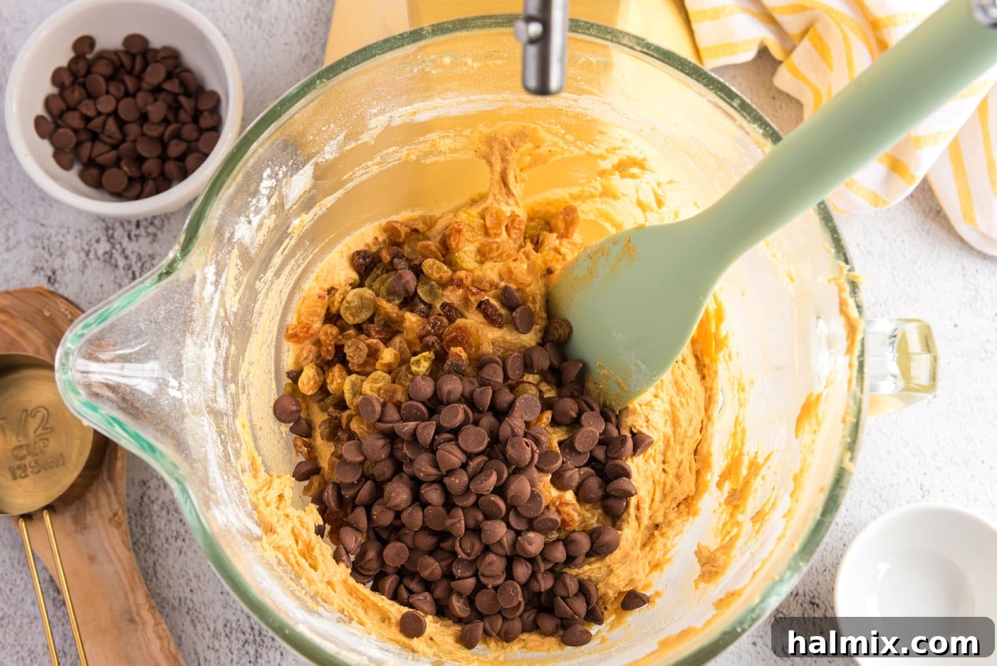 Harvest Pumpkin Chocolate Chip Muffins 15 adding chocolate chips and raisins to pumpkin muffin batter