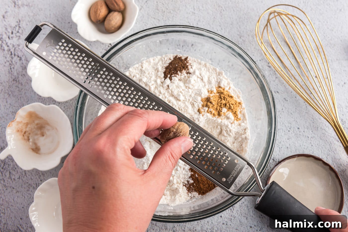 Harvest Pumpkin Chocolate Chip Muffins 5 grating nutmeg over flour mixture and spices in a bowl