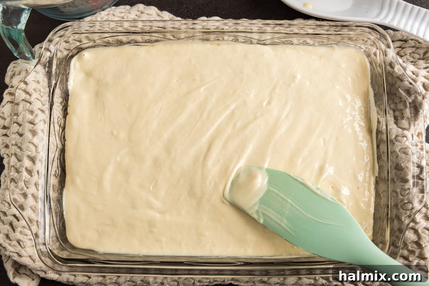 Crimson Raspberry Flip 11 Spreading cake batter smoothly over the raspberries and brown sugar mixture in the baking dish