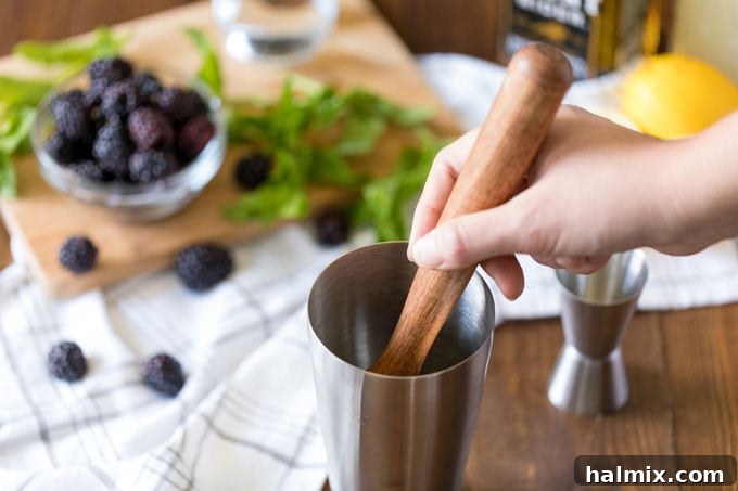 Twilight Berry Bourbonade 4 muddling cocktail ingredients in a shaker