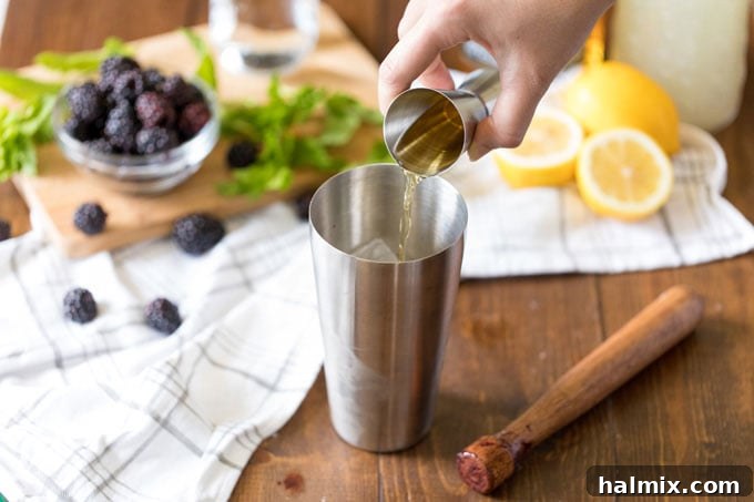 Twilight Berry Bourbonade 5 adding bourbon whiskey to cocktail shaker