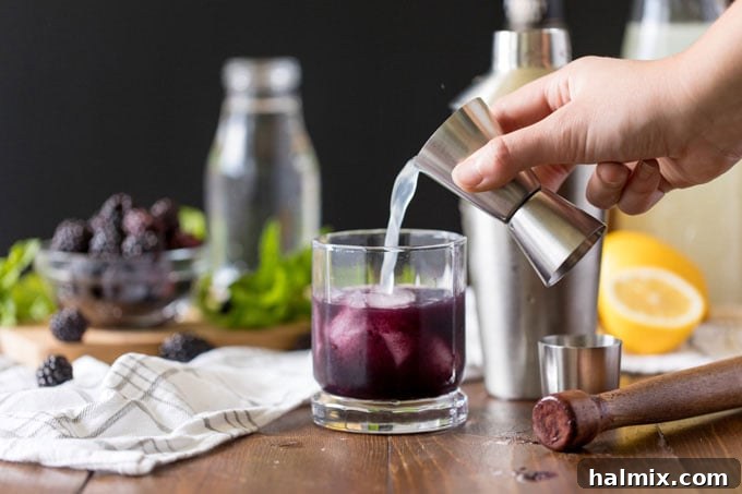 Twilight Berry Bourbonade 6 pouring lemonade into glass
