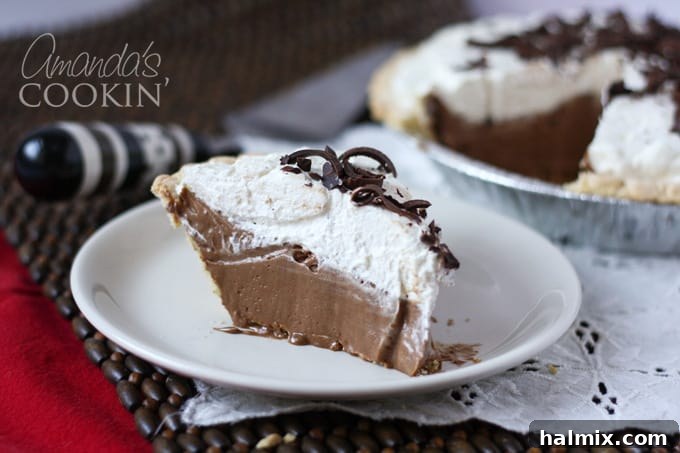 Decadent French Silk Delight 18 A beautiful slice of French Silk Pie on a plate, highlighting its rich chocolate filling, fluffy whipped cream, and chocolate shavings.