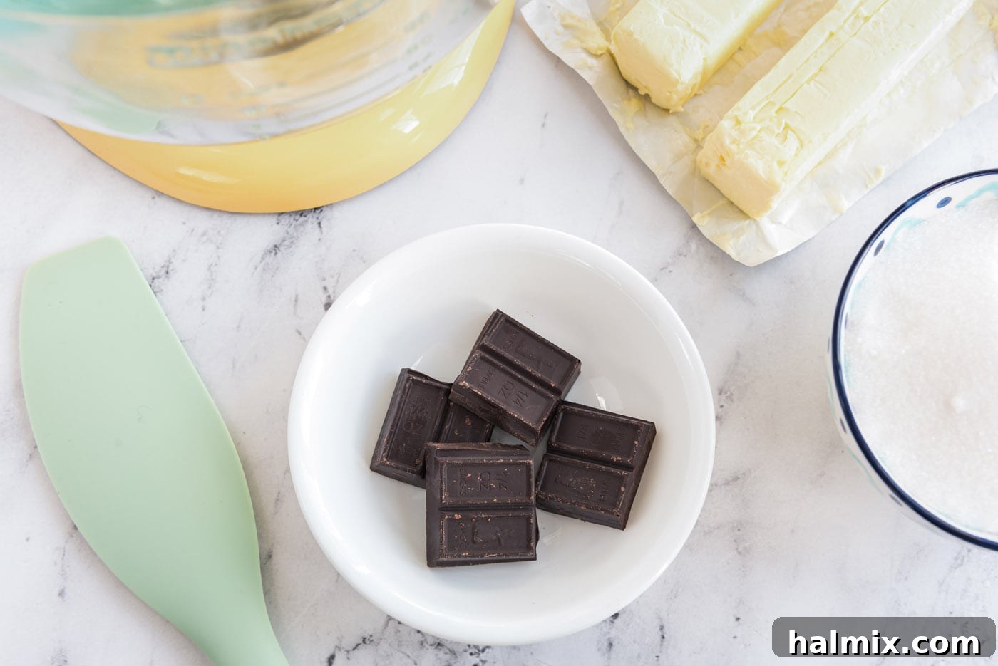 Unsweetened chocolate squares in a small bowl, ready for melting.