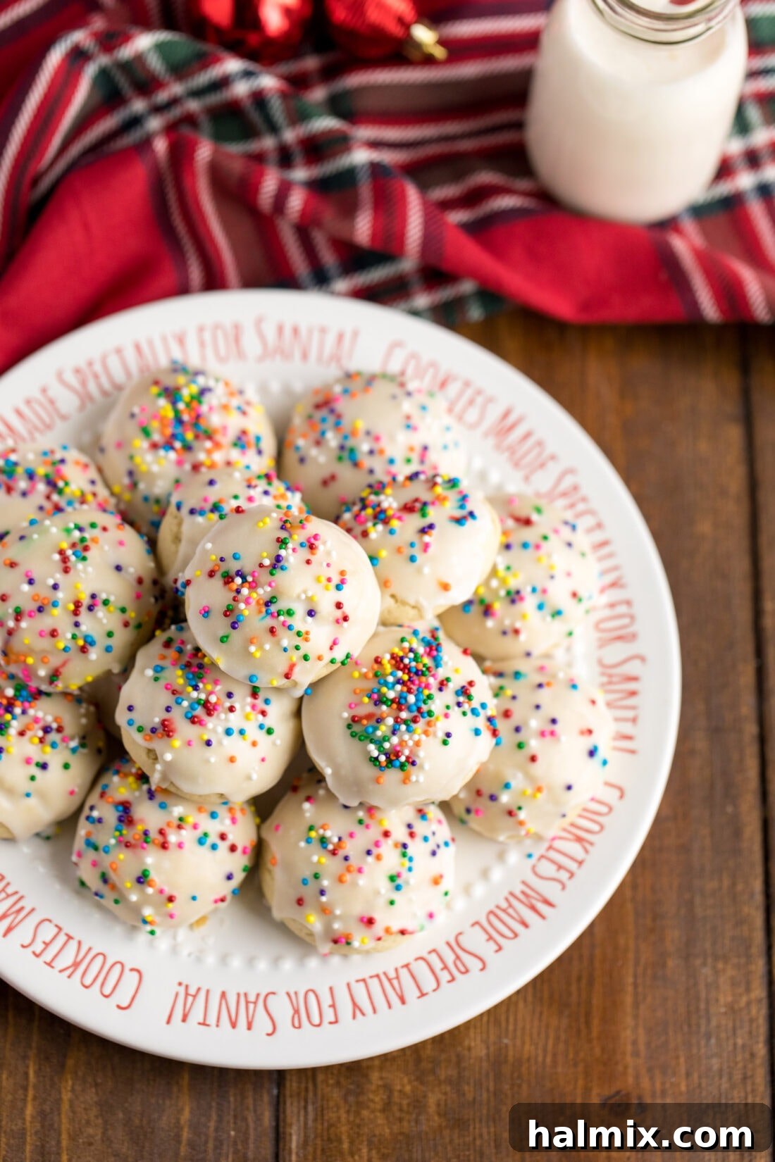 A plate brimming with freshly baked Italian Anisette Cookies, coated in a sweet glaze and colorful sprinkles.