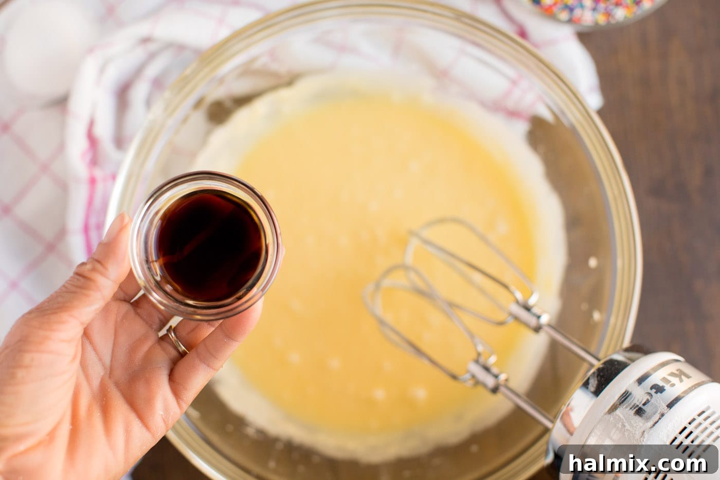 Cookie batter in a mixing bowl, showcasing the smooth consistency after adding eggs and extract.
