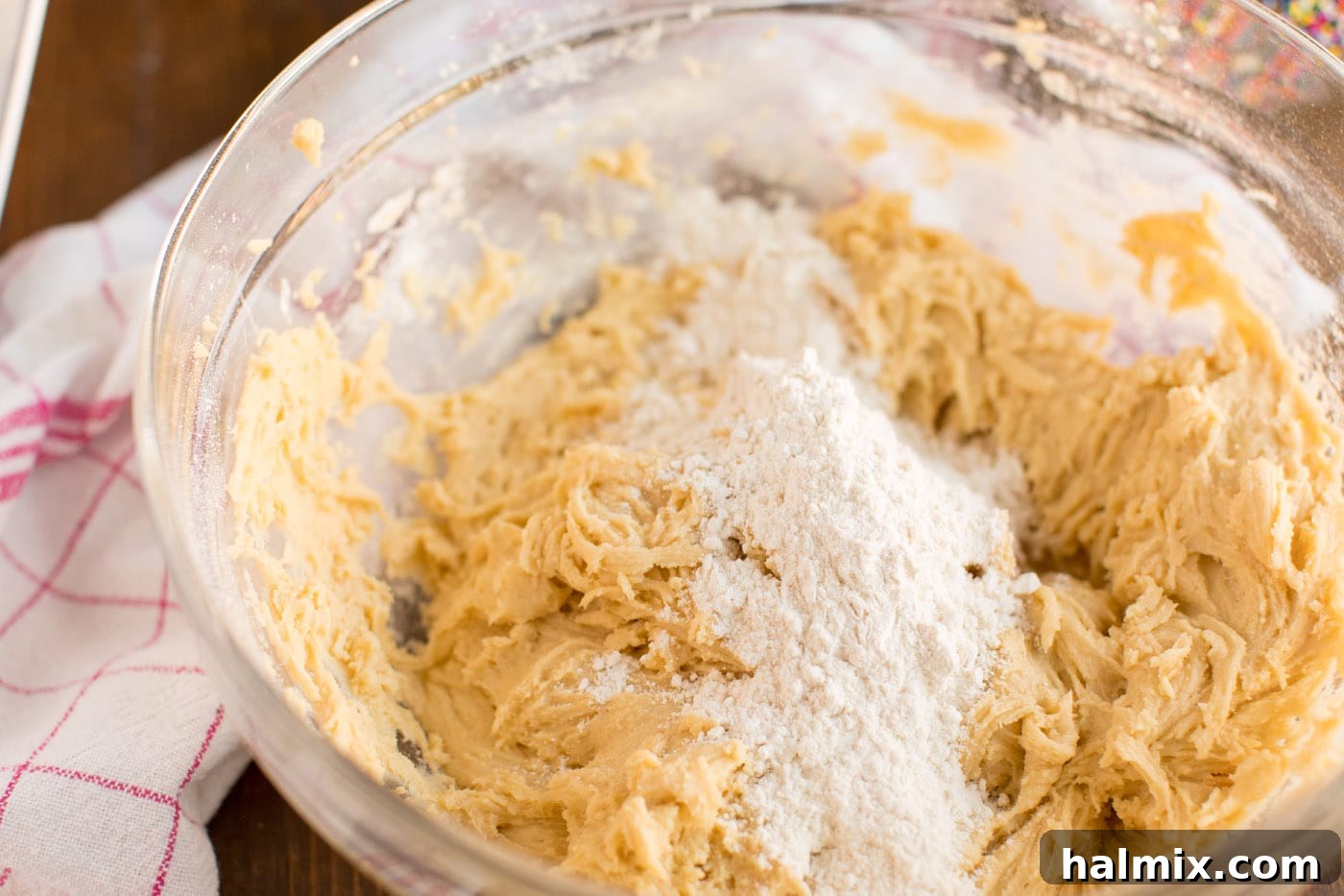 Cookie dough being mixed in a bowl, showing its soft and pliable state.