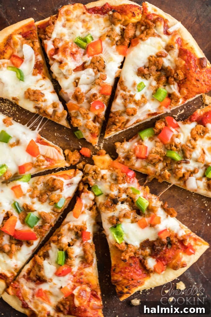 Perfect Homemade Pizza Crust 2 sliced pizza on a wooden board with fresh basil