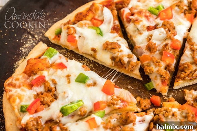 Perfect Homemade Pizza Crust 4 sliced pizza on a serving board