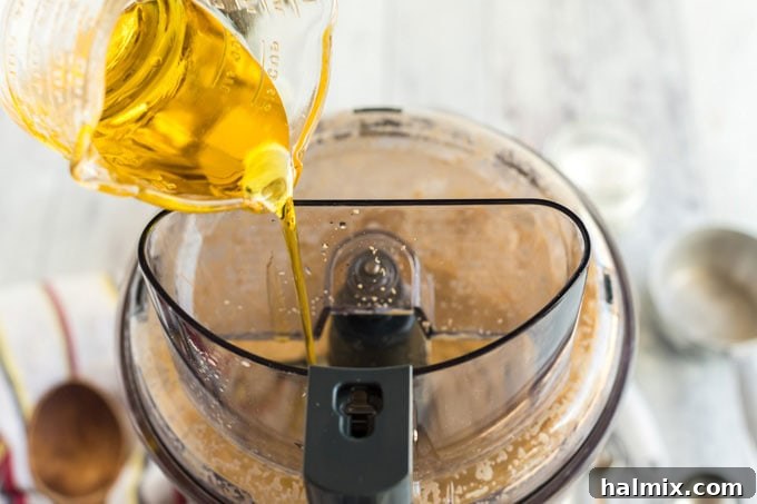 Perfect Homemade Pizza Crust 7 adding olive oil to food processor
