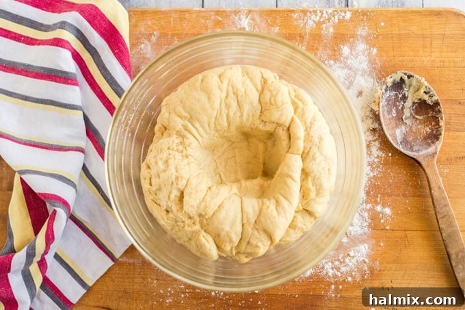 Perfect Homemade Pizza Crust 10 dough punched down in a bowl
