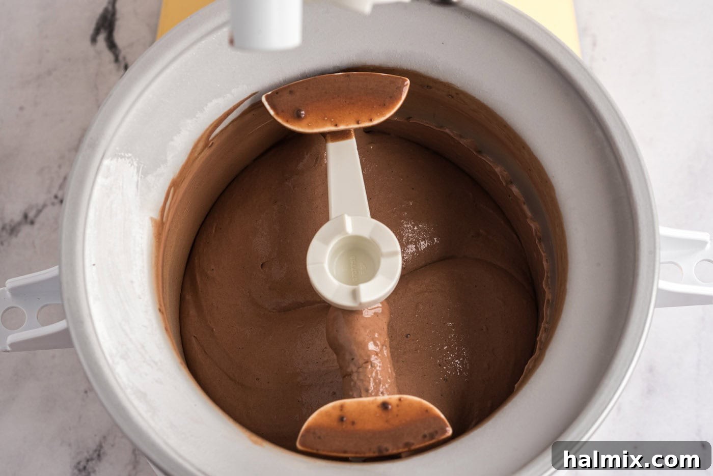 churning chocolate ice cream in an ice cream maker
