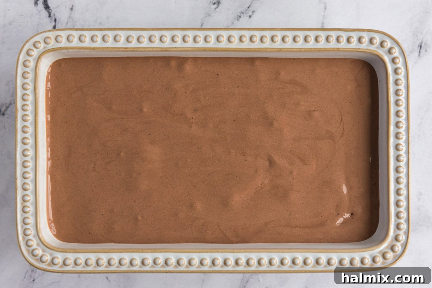 homemade chocolate ice cream mixture in a loaf pan