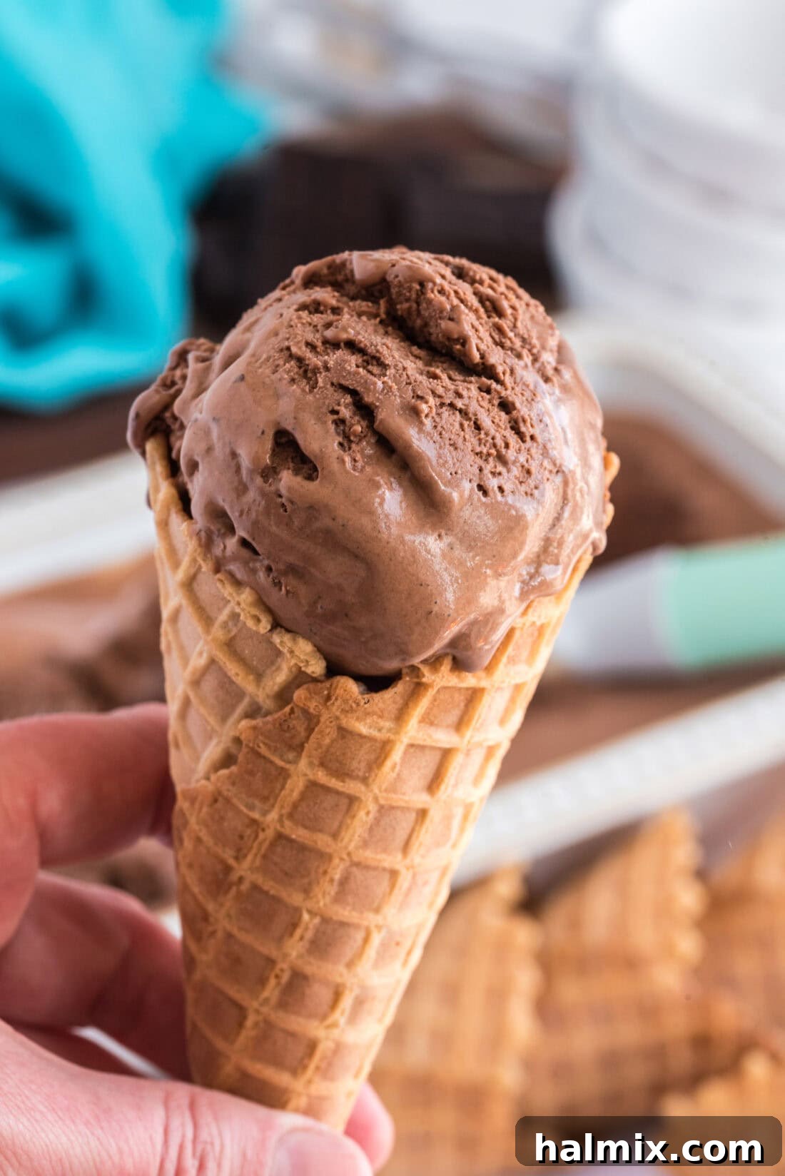 Hand holding a cone of Homemade Chocolate Ice Cream