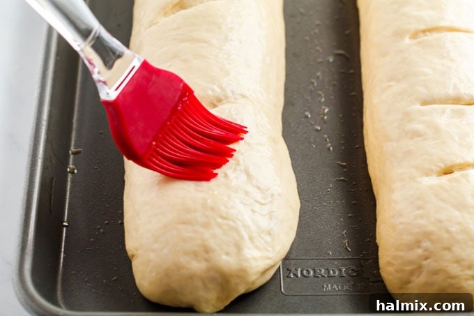 brushing top of bread loaves