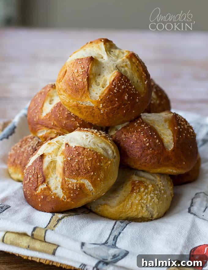 A stack of golden-brown bretzel rolls, showcasing their perfect bake and inviting texture.