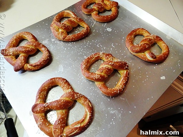An overhead of homemade German pretzels on a baking sheet.