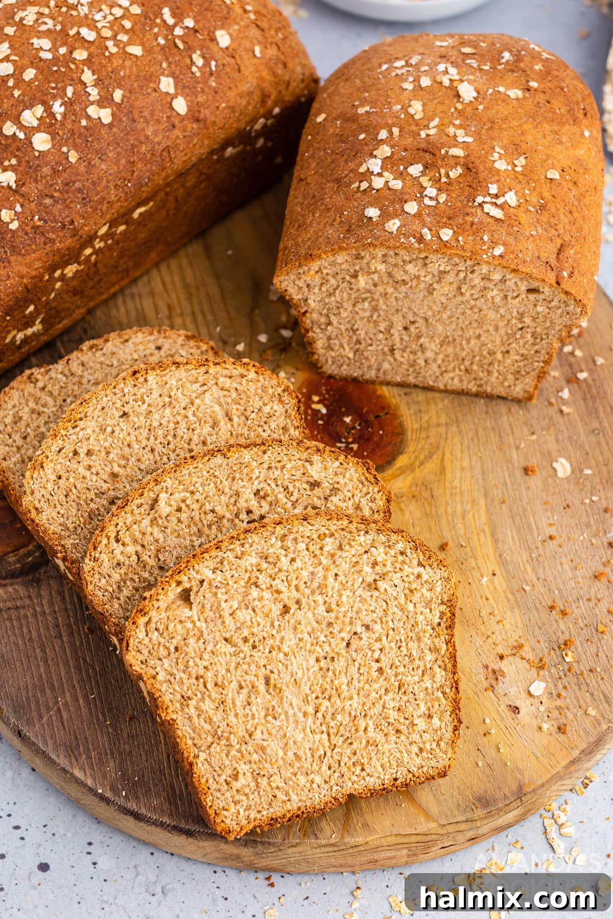 Delicious multigrain bread, expertly sliced and arranged on a rustic wooden board, ready for enjoyment.