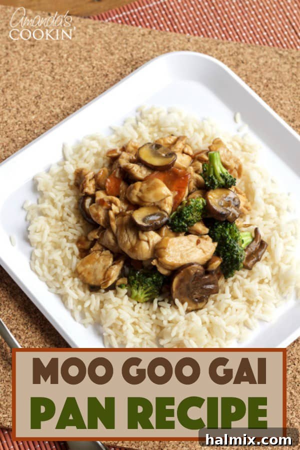 A plate of chicken and vegetables with rice, ready to be eaten.