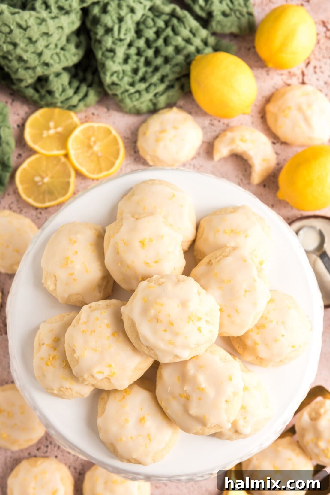 Tangy Lemon Clouds 2 Lemon Drop Cookies piled on a plate, showcasing their soft texture and vibrant glaze