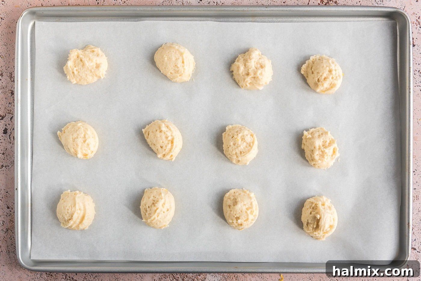 Tangy Lemon Clouds 13 Cookie dough balls on a baking sheet before baking