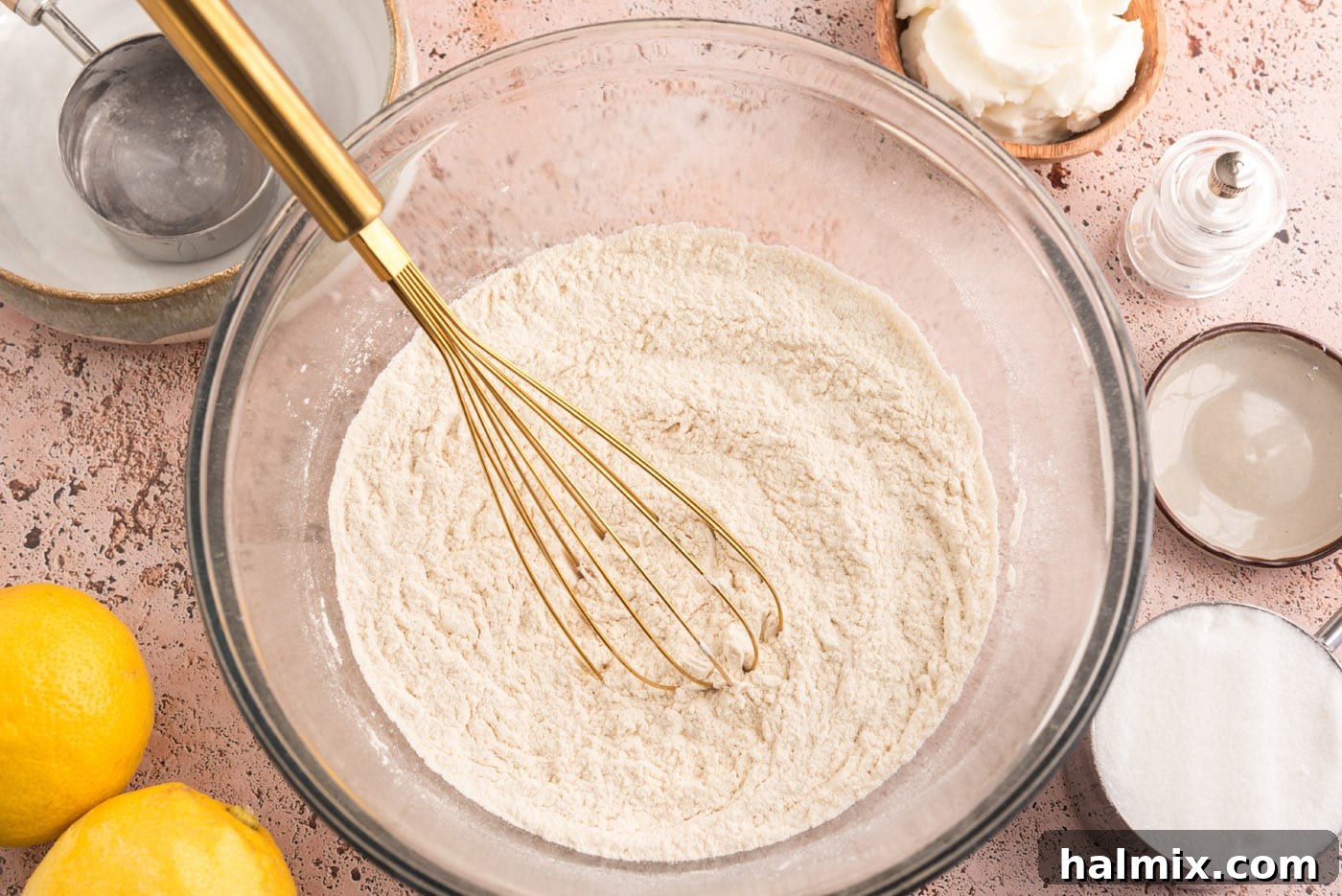 Tangy Lemon Clouds 5 Flour mixture in a bowl with a whisk, ready to be combined with wet ingredients