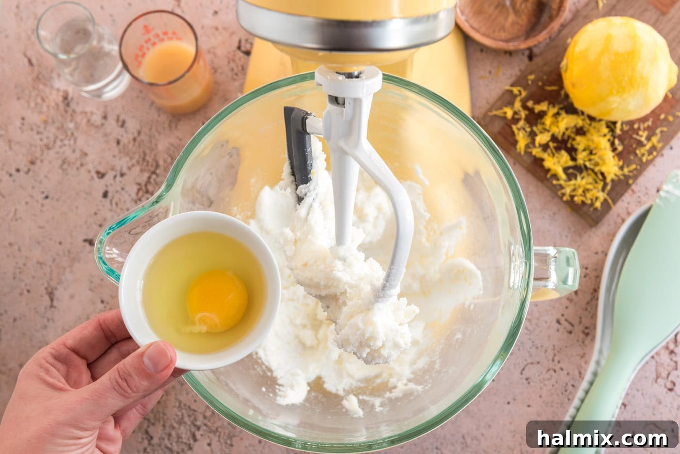 Tangy Lemon Clouds 9 Adding an egg to the lemon cookie dough mixture in a mixer