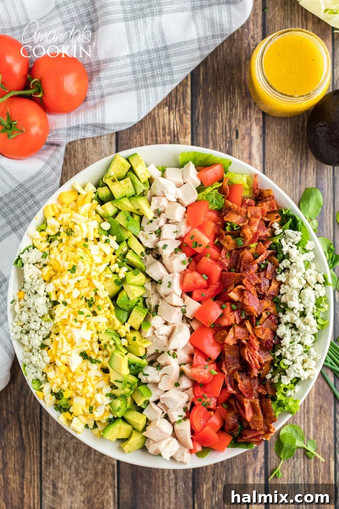 overhead photo of cobb salad - a beautifully arranged medley of fresh ingredients