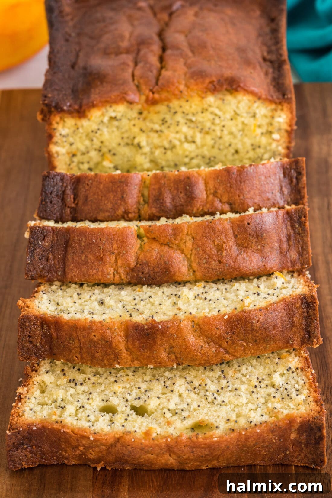 Deliciously sliced Orange Poppy Seed Pound Cake, showcasing its moist texture and uniform distribution of poppy seeds, ready to be enjoyed.