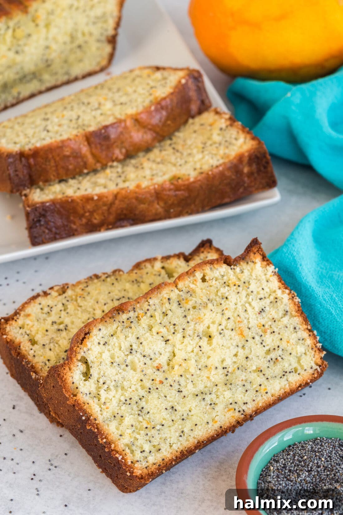 Two generous slices of Orange Poppy Seed Pound Cake, beautifully glazed and ready for serving, highlighting the golden crumb.