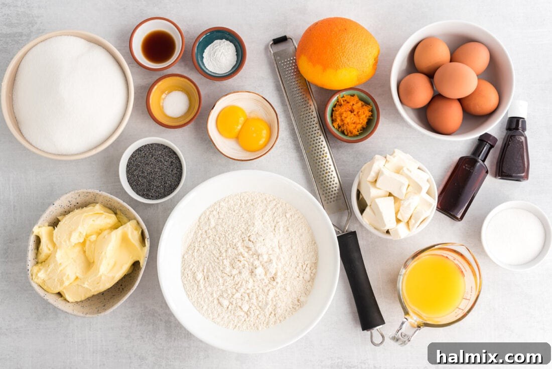 A collection of fresh ingredients laid out on a kitchen counter, including oranges, eggs, butter, flour, and poppy seeds, ready for baking Orange Poppy Seed Pound Cake.