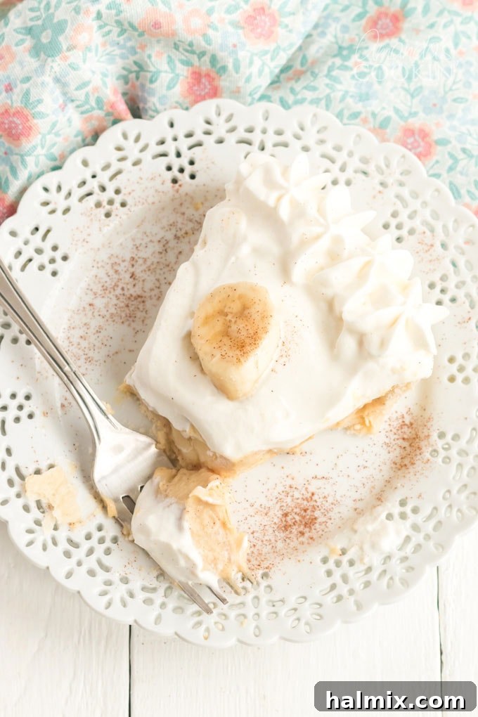 slice of banana cream pie with a fork on the plate