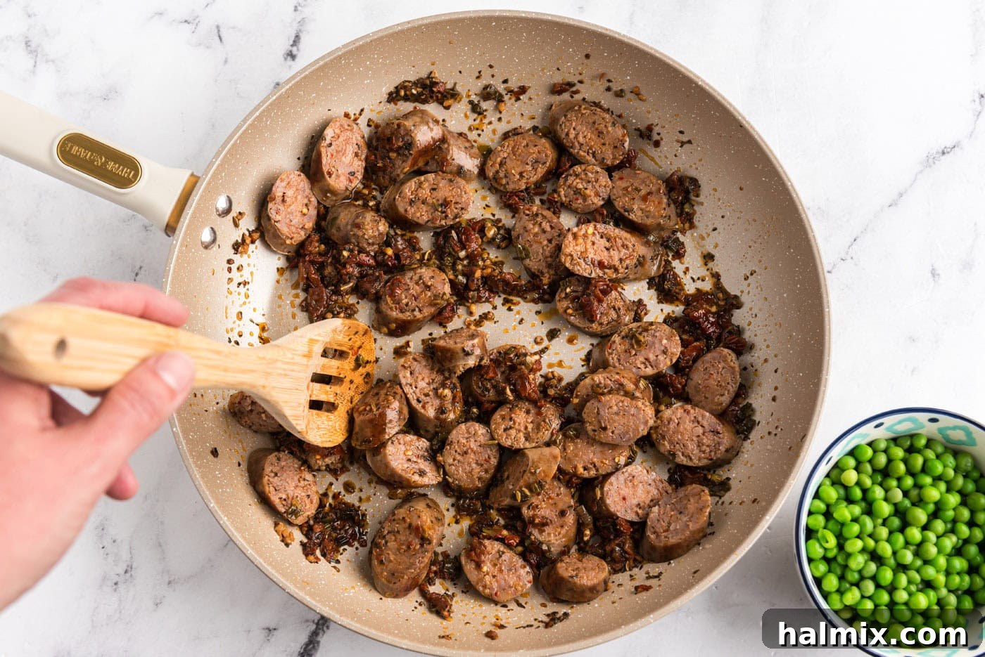 sliced Italian sausage added to skillet with sun dried tomato mixture