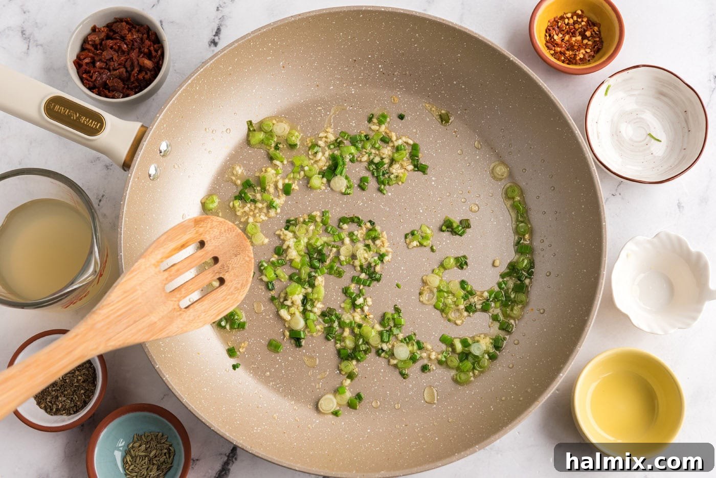 sauteeing garlic and scallions in a skillet