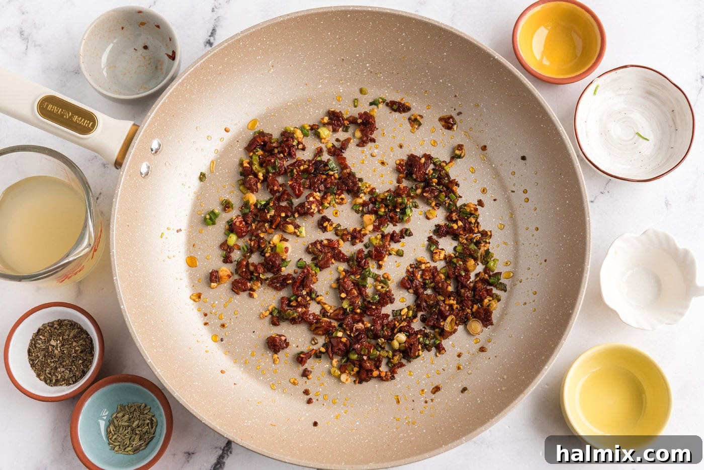 red pepper flakes and sun dried tomatoes added to skillet with garlic and green onions